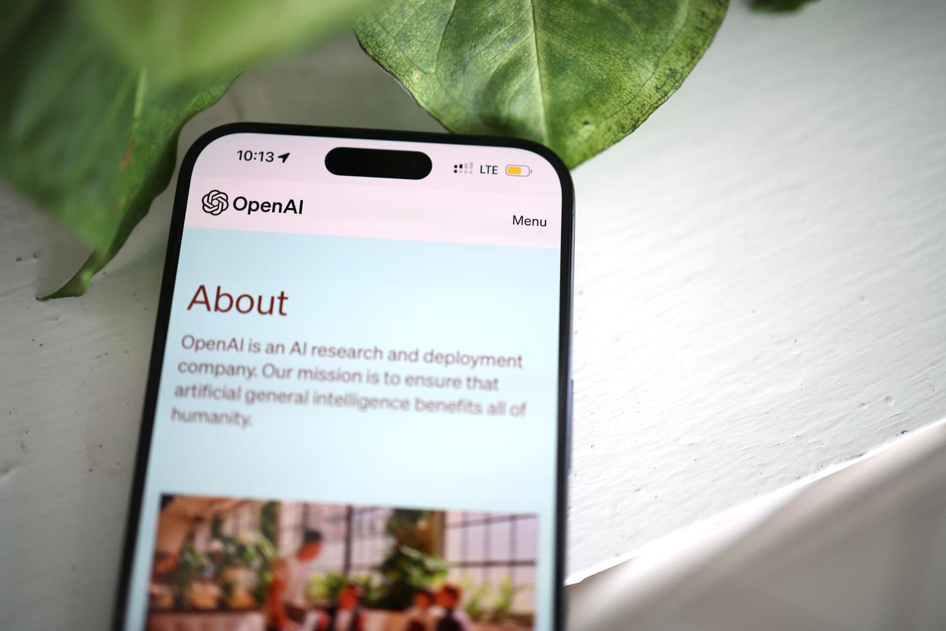 Person using a smartphone with AI-generated visuals and text overlay, symbolizing mobile-based AI income